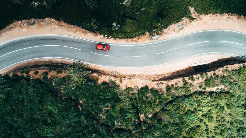 Aerial view of red car on road