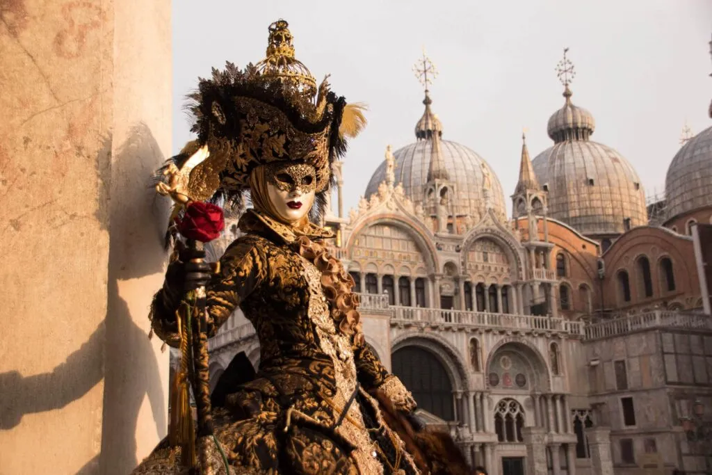 Person wearing historical Carnevale mask and costume