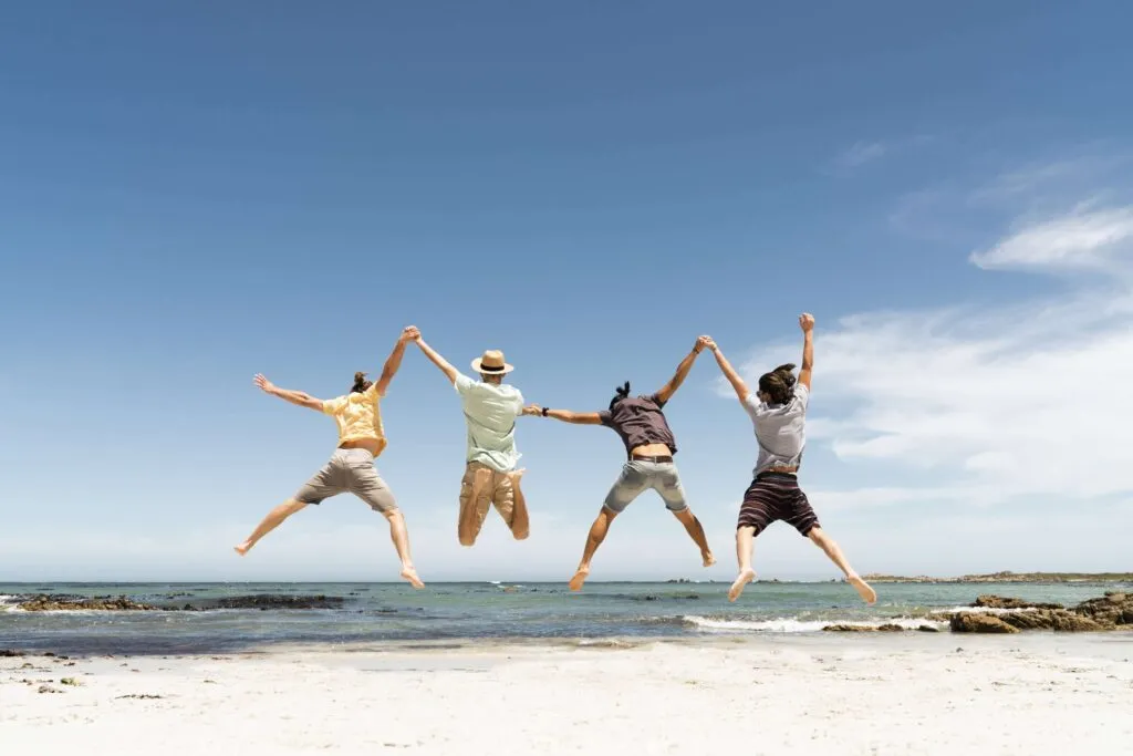 Friends jumping at the beach