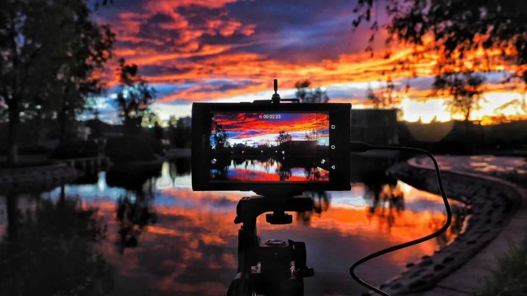 Camera taking photo of sunset
