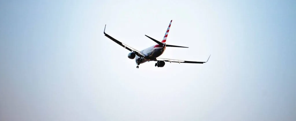 Plane in sky. Photo by Denisse Leon on Unsplash