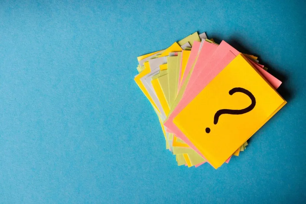 Question mark written on coloured post-it notes